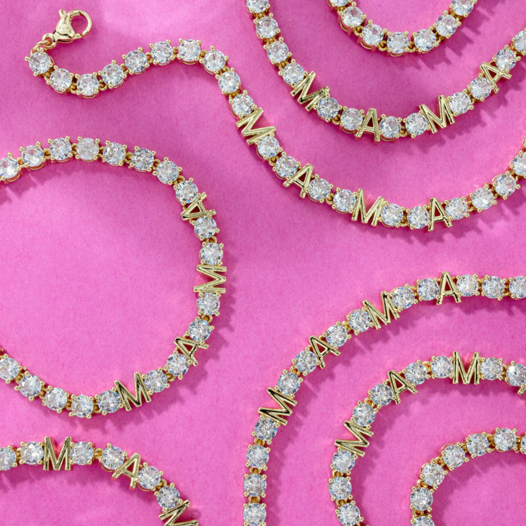 Gold and diamond bracelet on a pink background