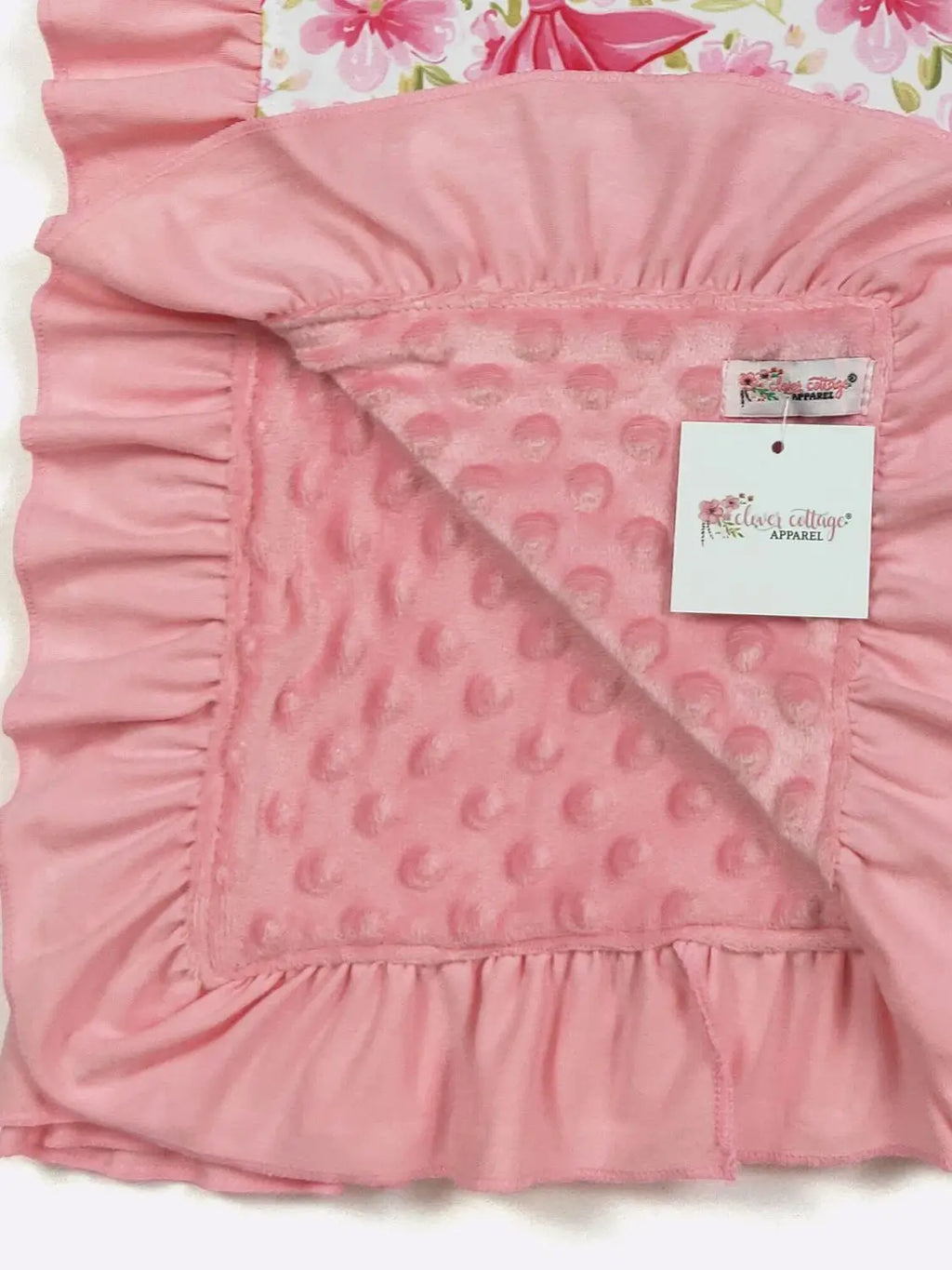Pink textured blanket with a tag on a white background