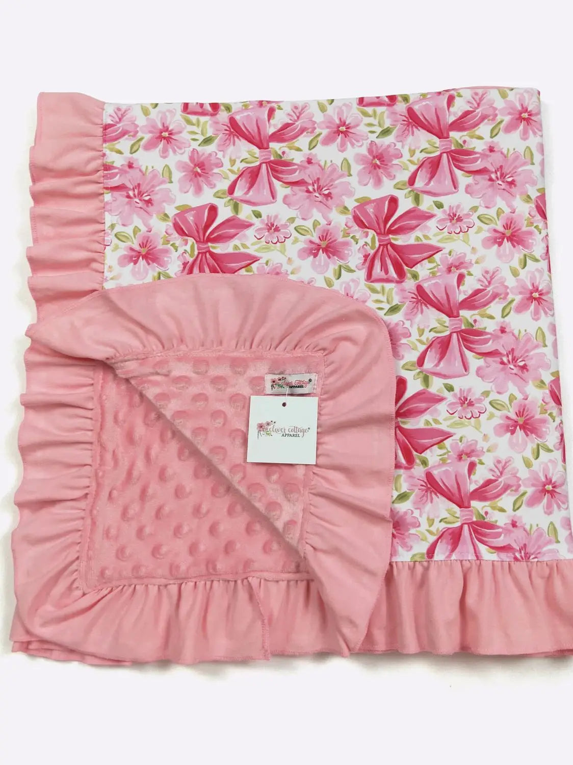 Pink floral baby blanket with ruffled edges on a white background