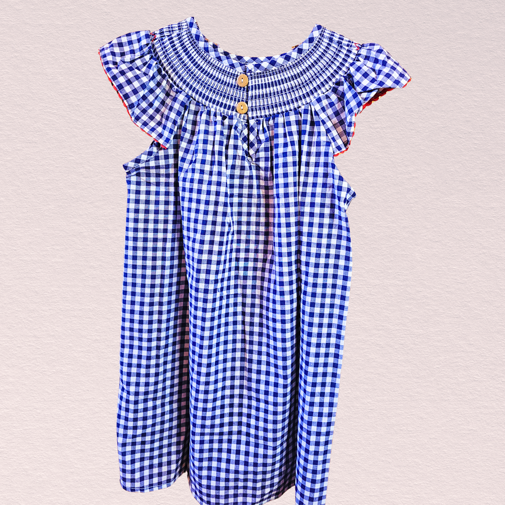The back of a blue and white checkered dress with ruffled sleeves on a light gray background