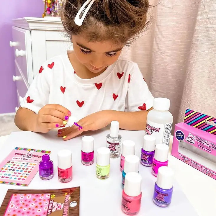 Child playing with nail polish bottles on a table