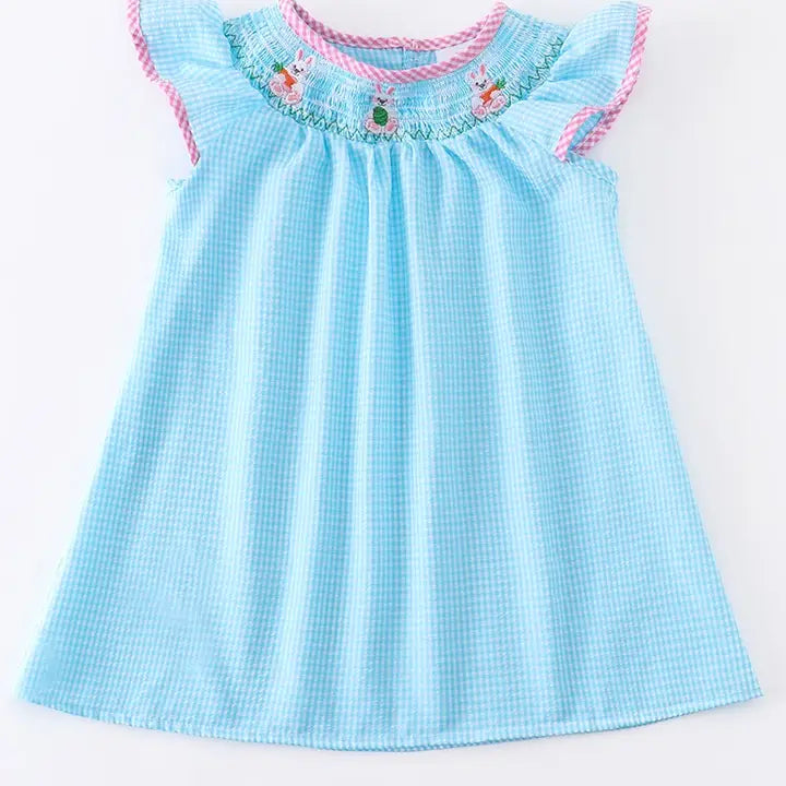 Light blue checkered dress with pink trim on a white background