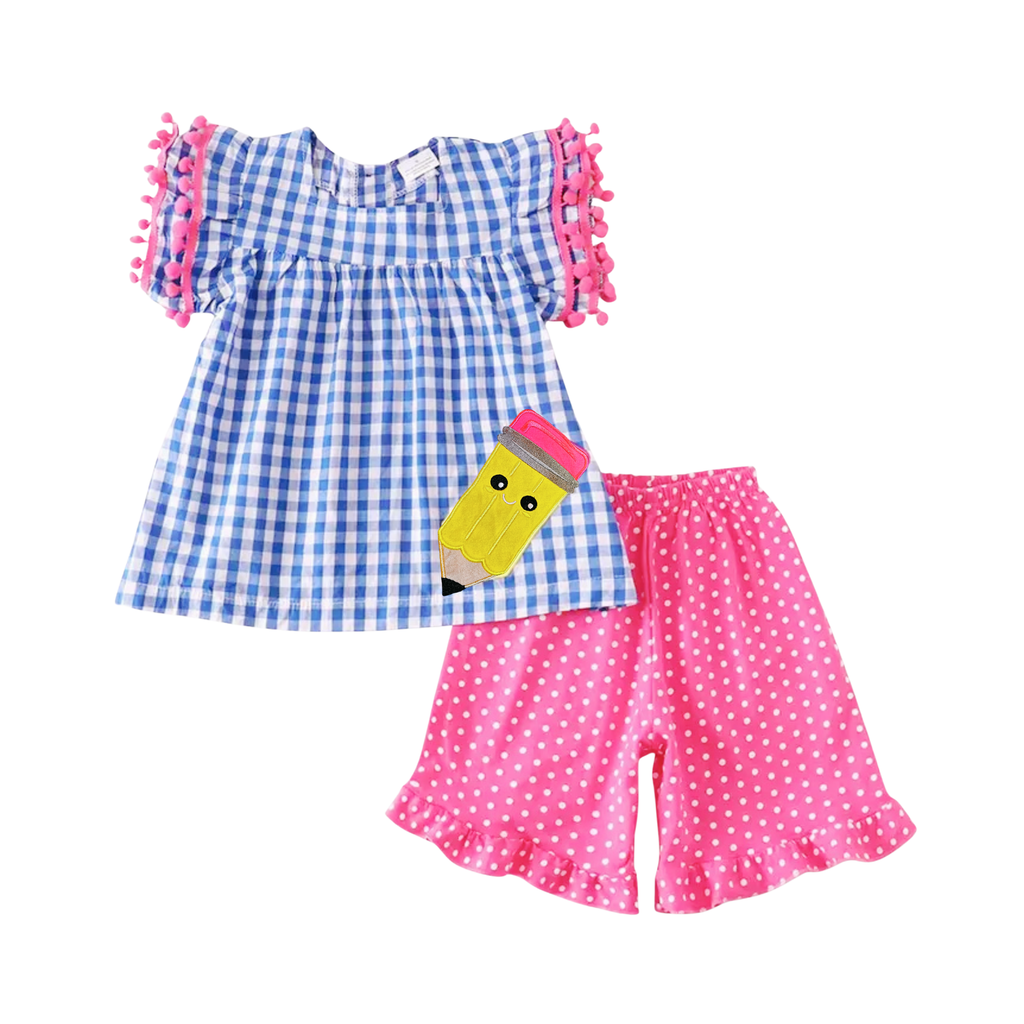 Children's outfit with blue checkered top and pink polka dot shorts on a white background