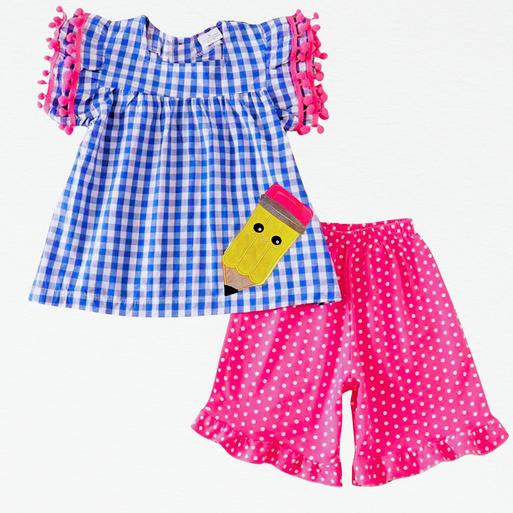 Children's outfit with blue checkered top and pink polka dot shorts on a white background