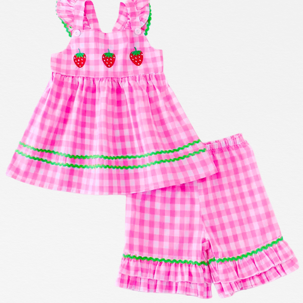 Pink checkered dress and shorts set with strawberry details on a white background
