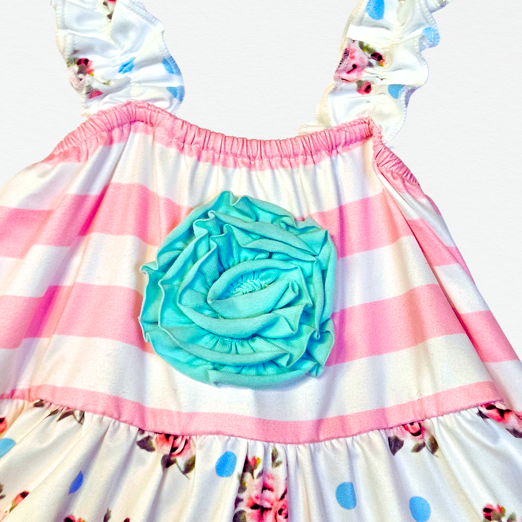 Children's dress with pink and white checkered skirt, blue rose detail, and floral patterns on a white background