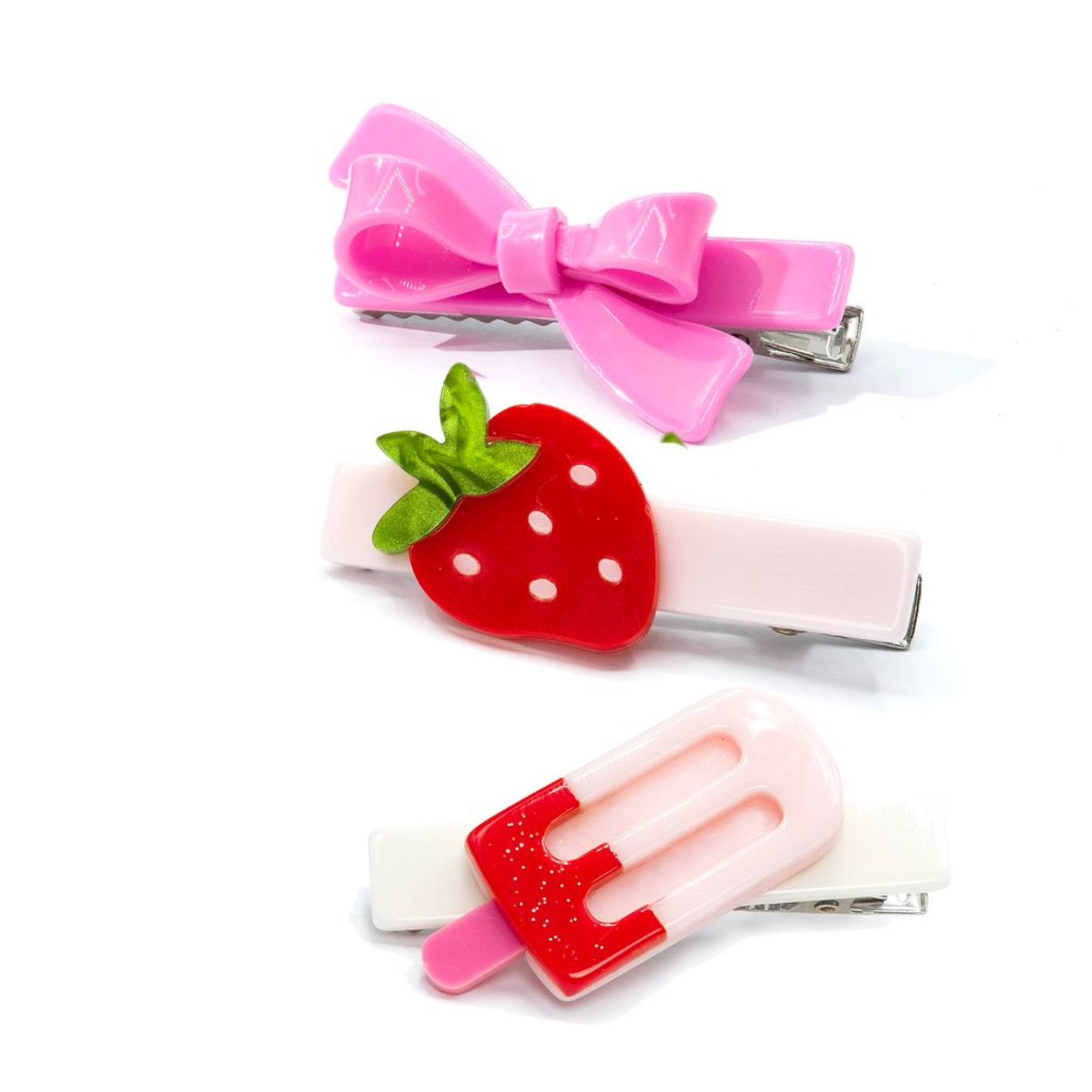 Three colorful hair clips on a white background