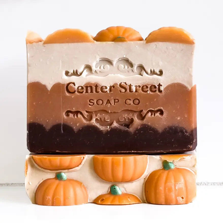 Bar of soap with pumpkin decorations and 'Center Street Soap Co' branding on a white background