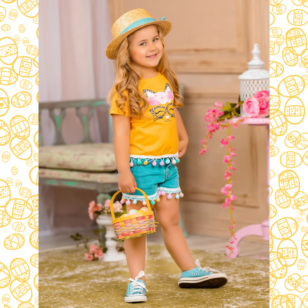 Young girl in a yellow shirt and blue shorts holding a Easter basket with decorative eggs.