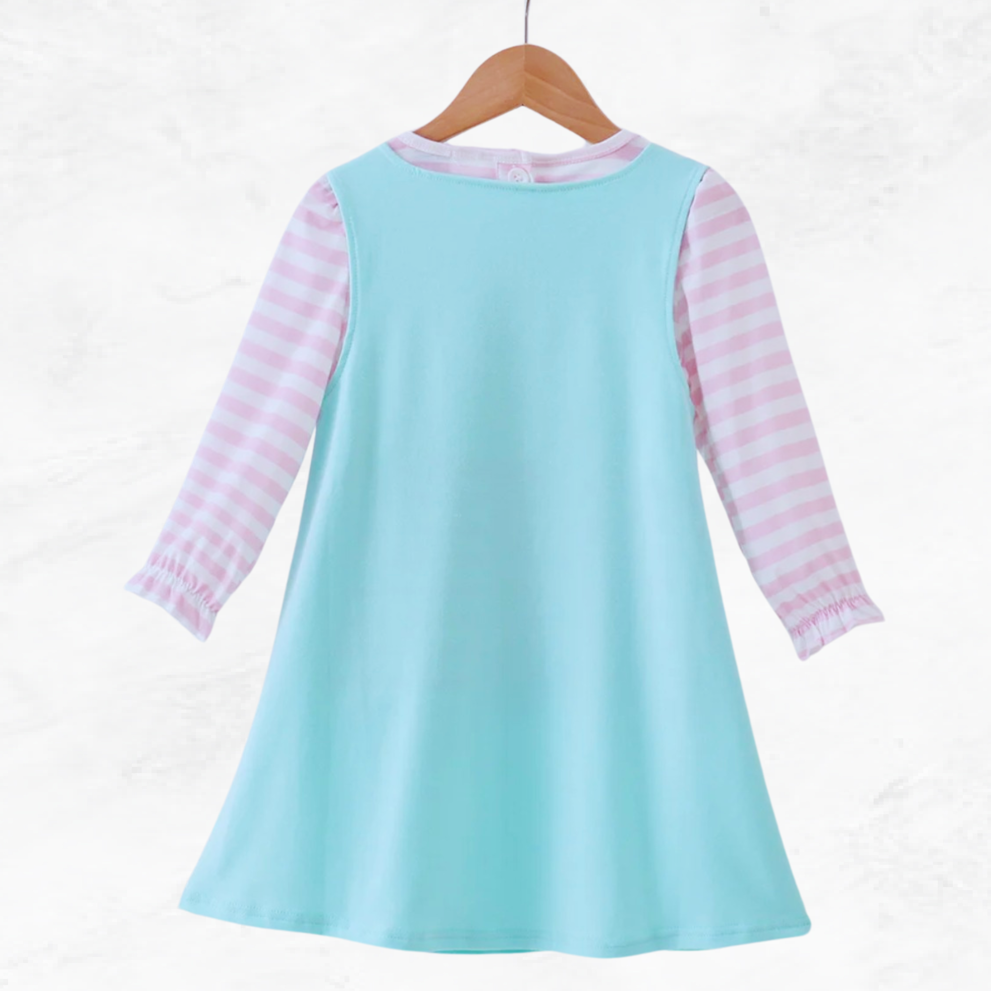 Light blue dress with pink striped sleeves on a wooden hanger against a white background