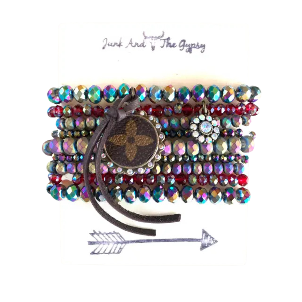 Multicolored beaded bracelet with a central brown button and 'Junk and The Gypsy' branding.