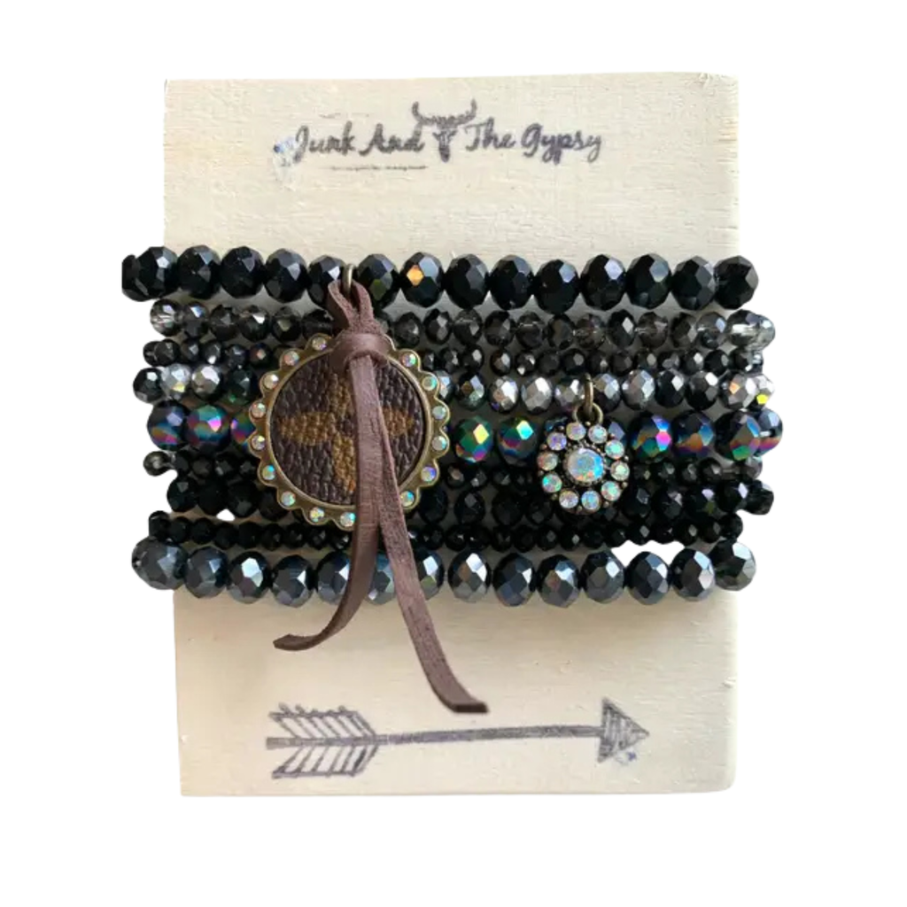 Set of beaded bracelets with a leather accent on a branded card.