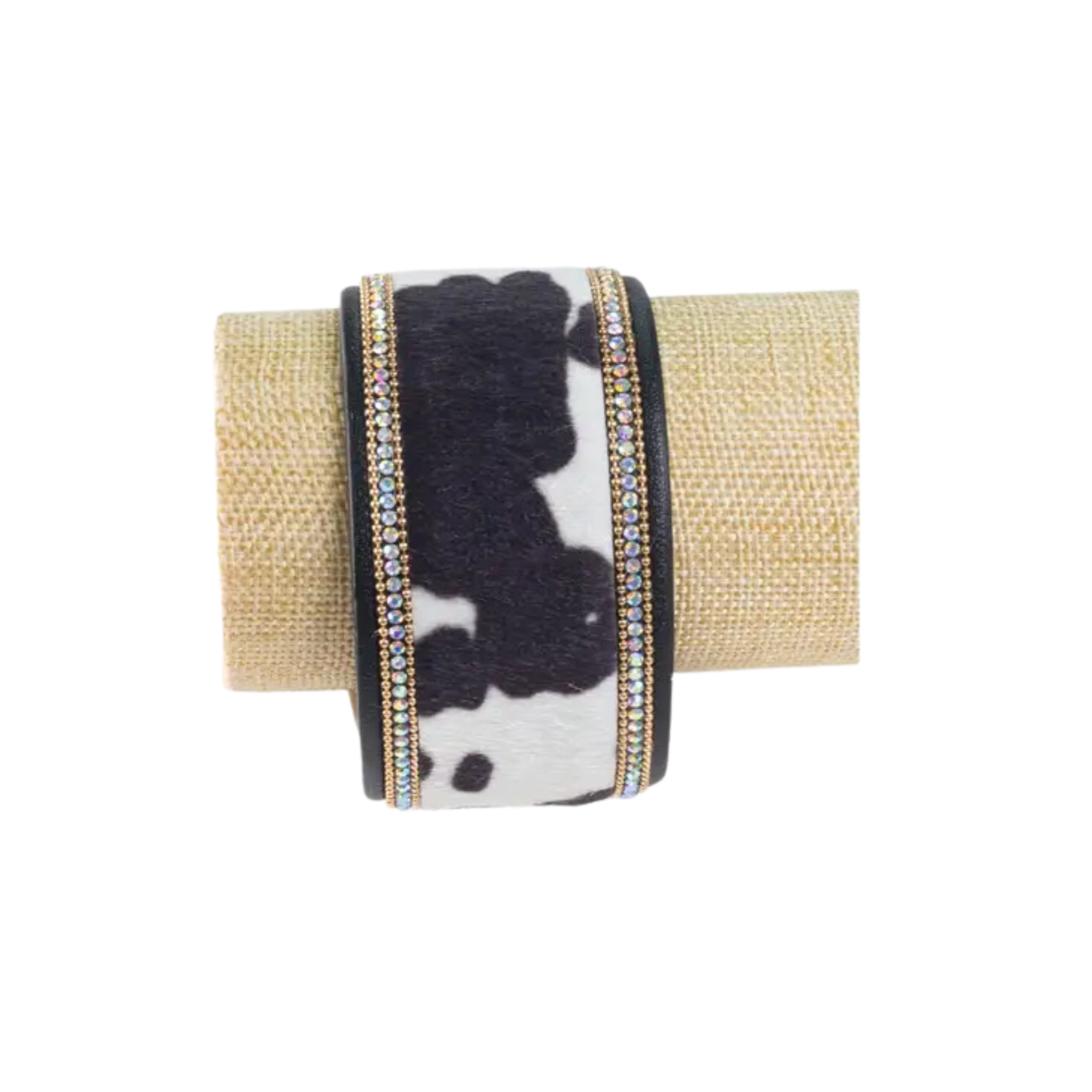 Bracelet with black and white pattern and gold accents on a beige background