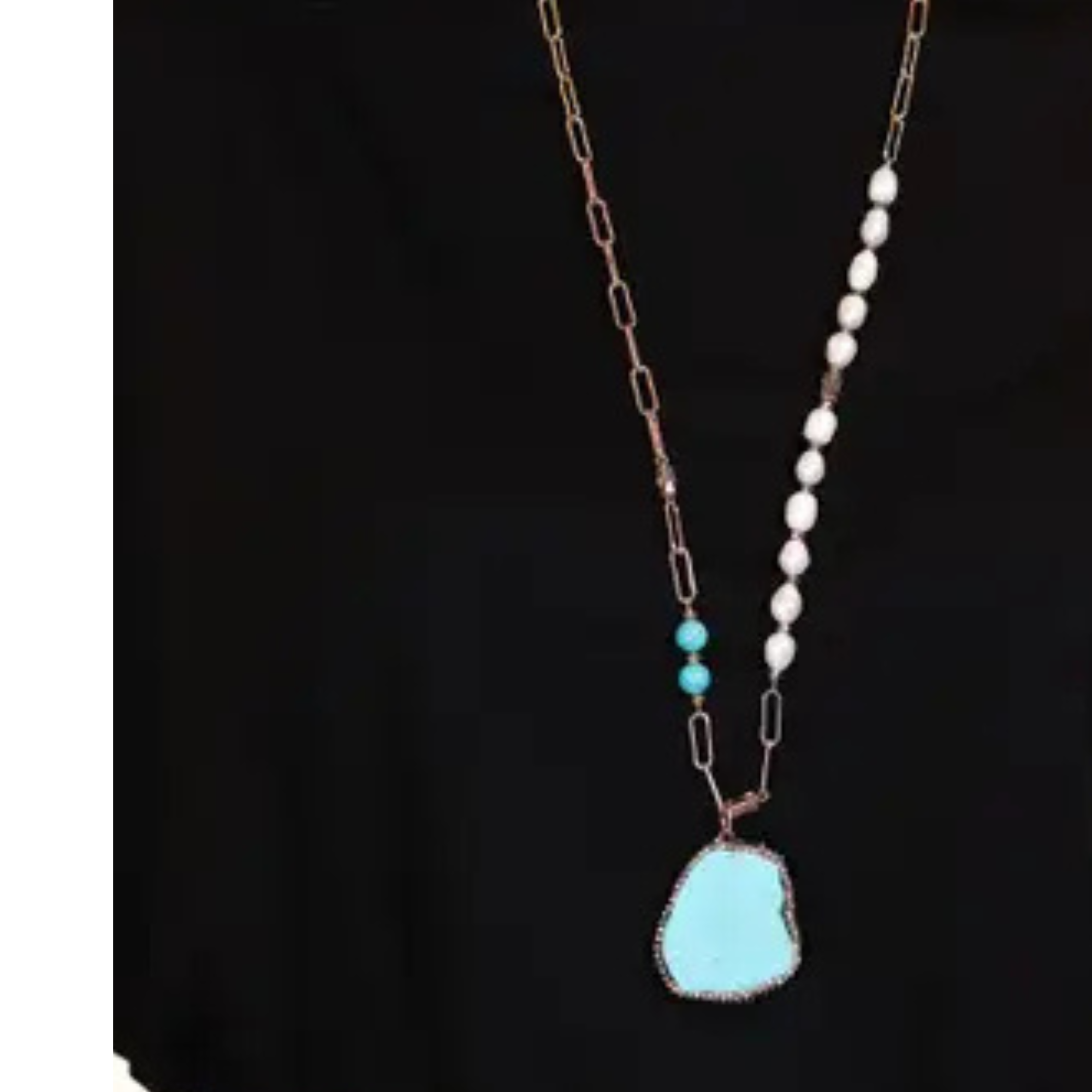 Necklace with turquoise pendant and white beads on a black background