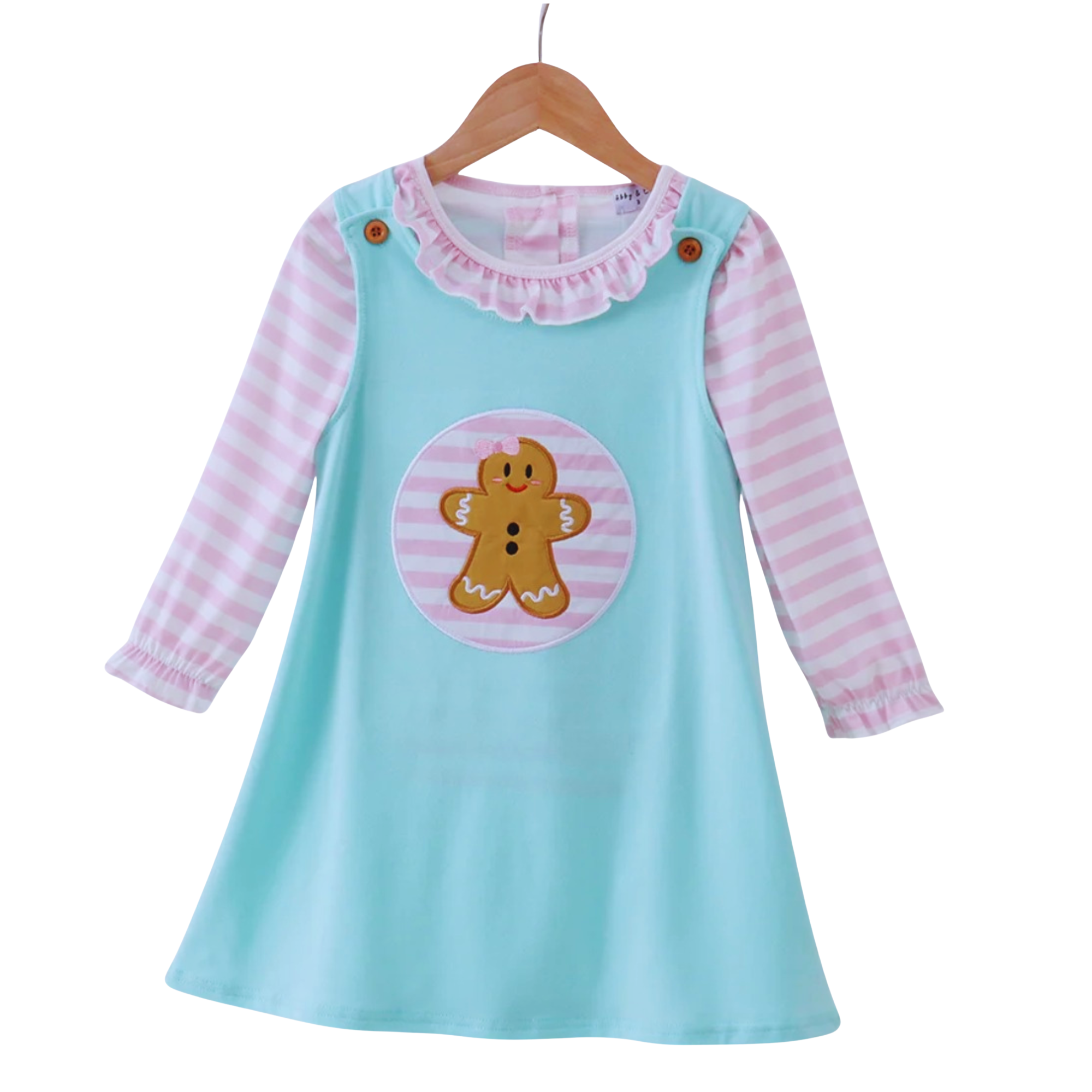 Children's dress with gingerbread man design on a hanger against a white background