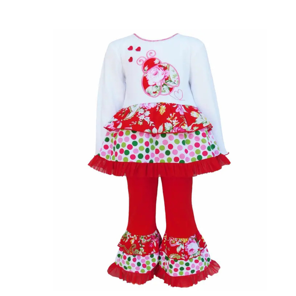 Children's outfit with a white top, red skirt, and red pants with ruffles on a white background