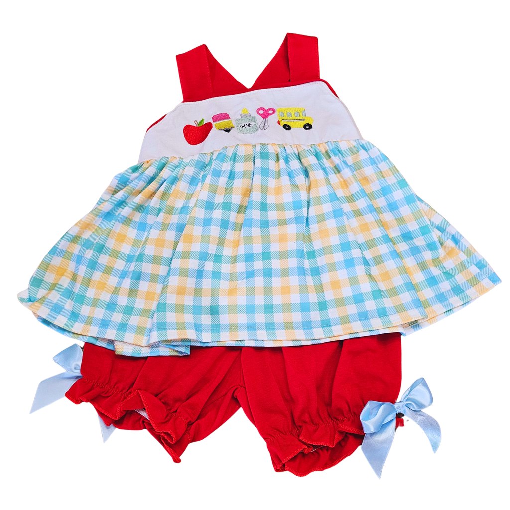 Children's dress with checkered skirt and red shorts on a white background