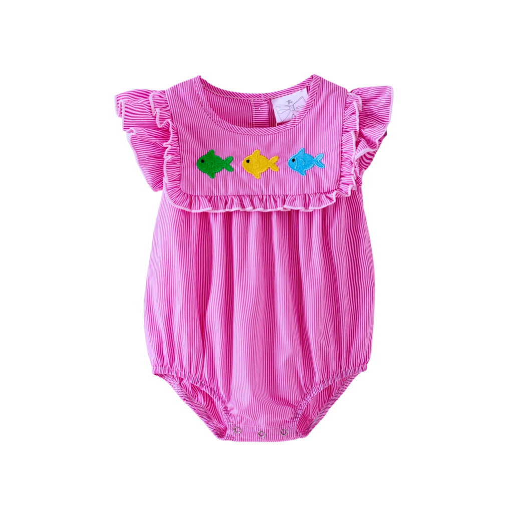 Pink baby romper with fish designs on a white background