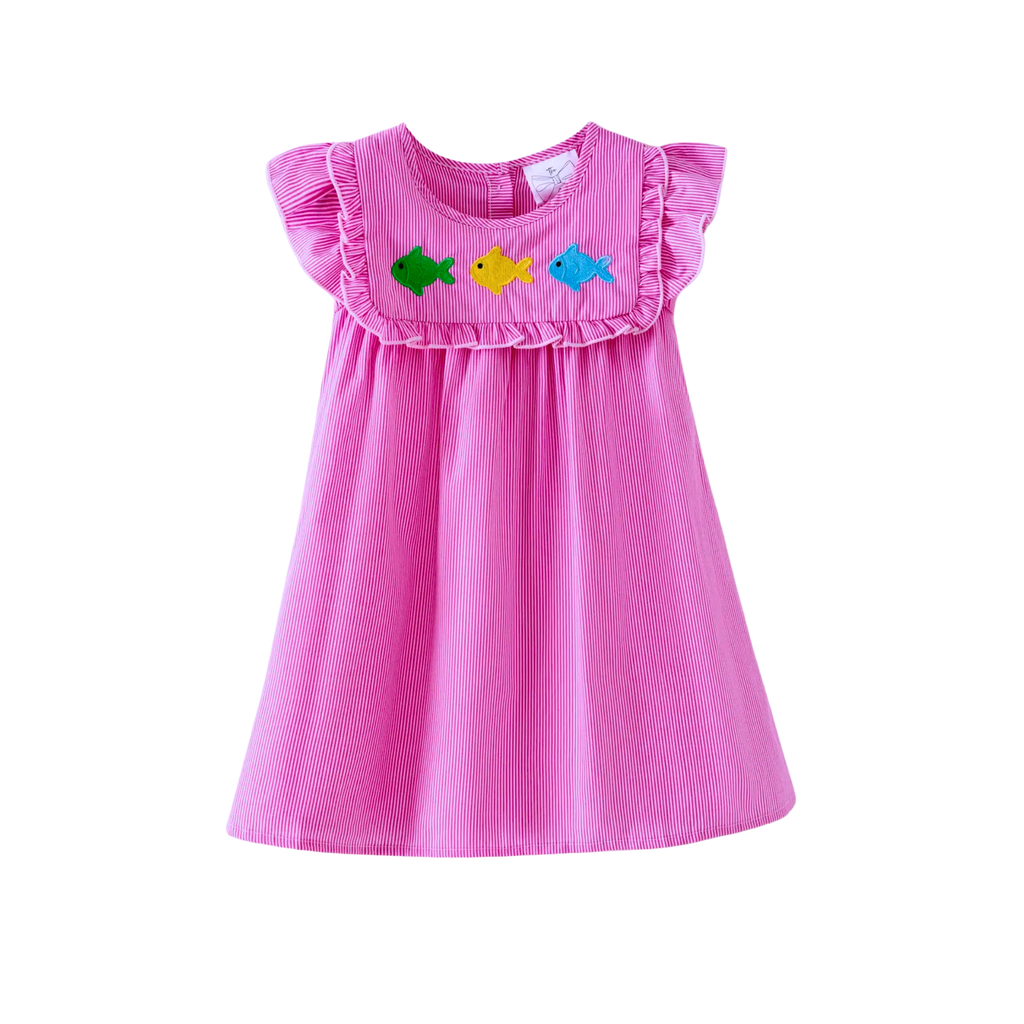 Pink dress with fish appliqués on a white background