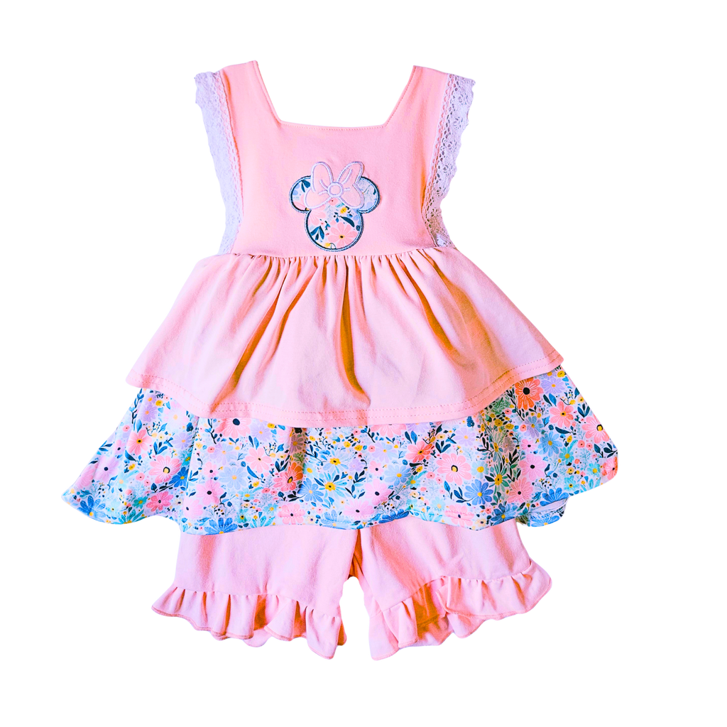 Pink children's dress with floral design on a white background