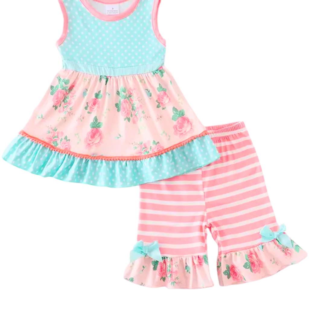 Children's outfit with floral top and striped pants on a white background