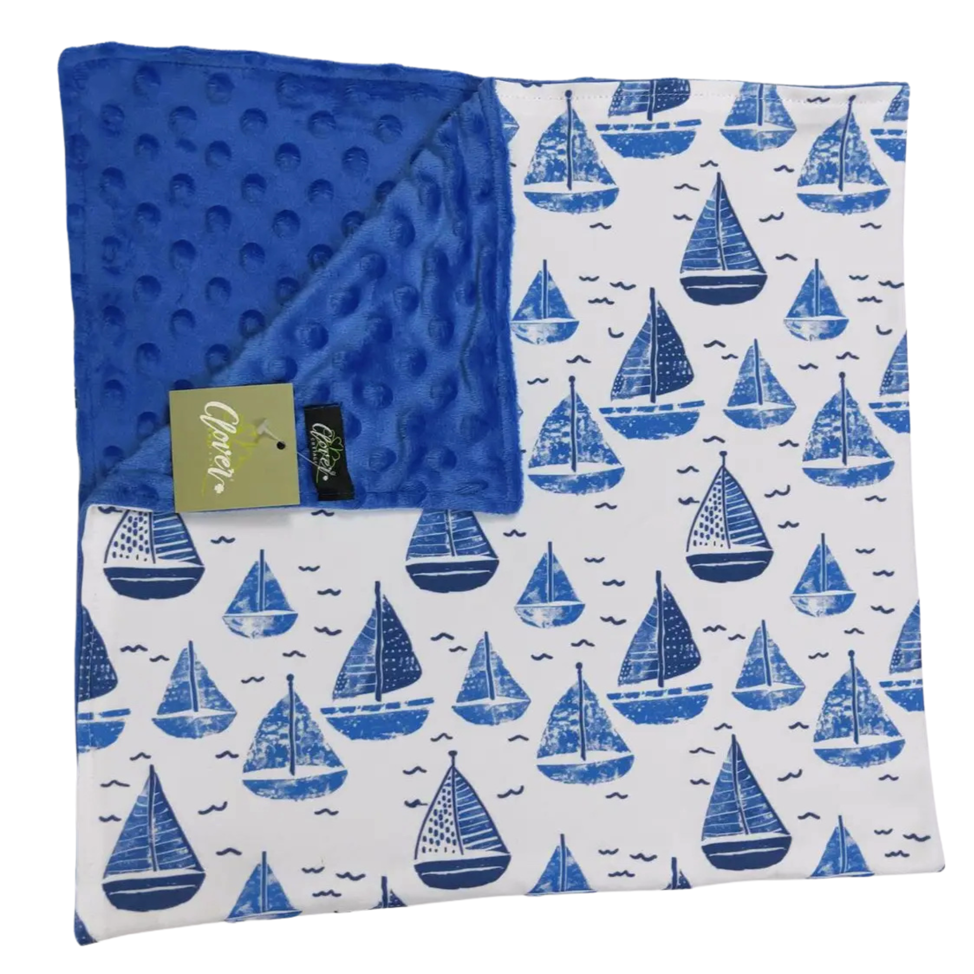 Baby blanket with blue sailboat pattern on a white background