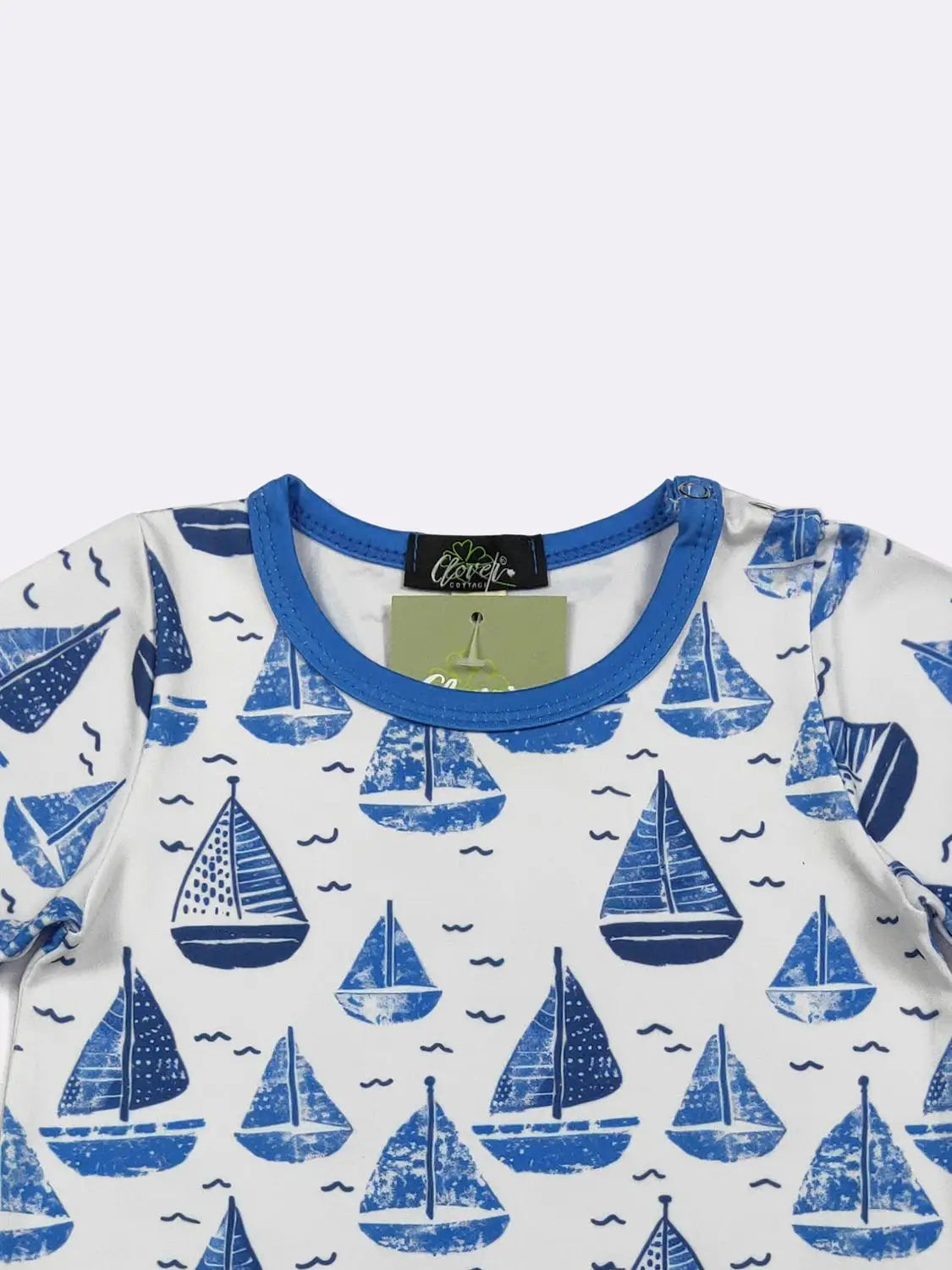 Children's t-shirt with blue sailboat pattern on a white background