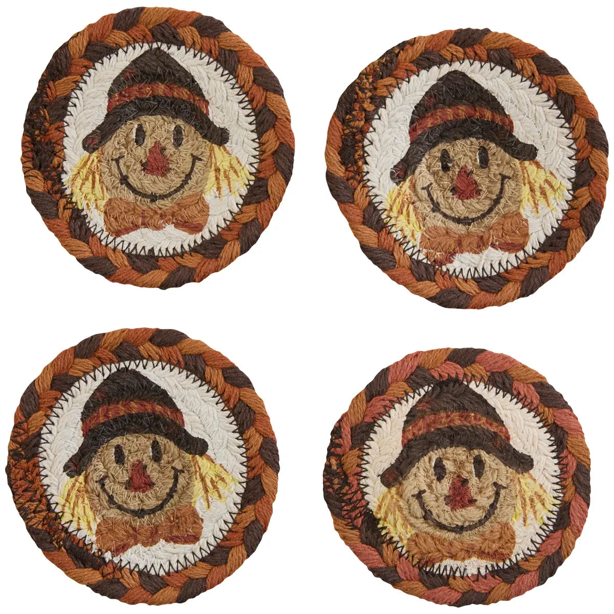 Four round coasters with scarecrow designs on a white background
