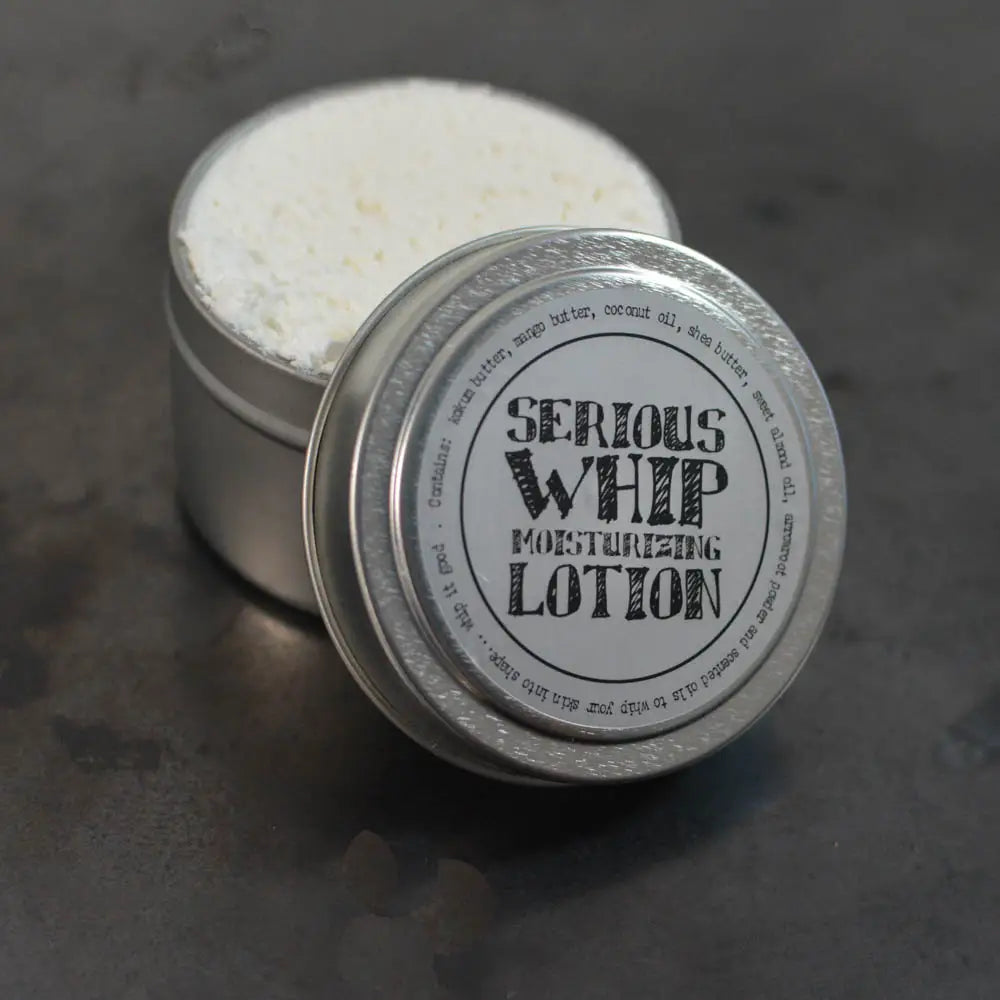 Metallic container of 'Serious Whip Moisturizing Lotion' with white cream inside on a dark surface.