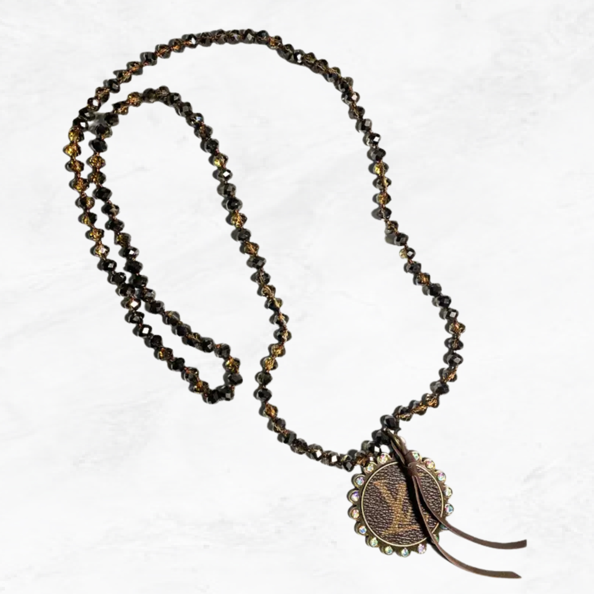 Necklace with beads and a decorative pendant on a white background