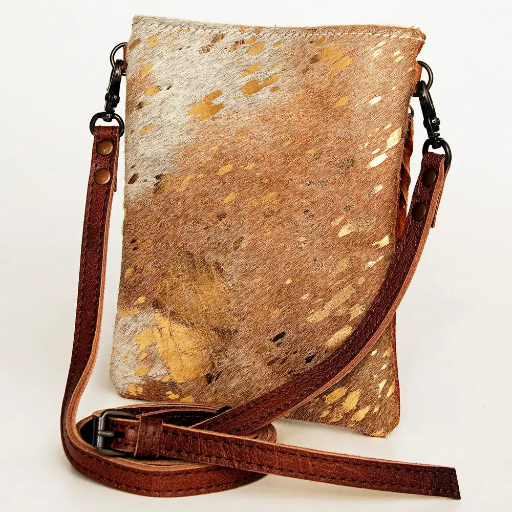 Brown and beige cowhide leather crossbody bag on a white background