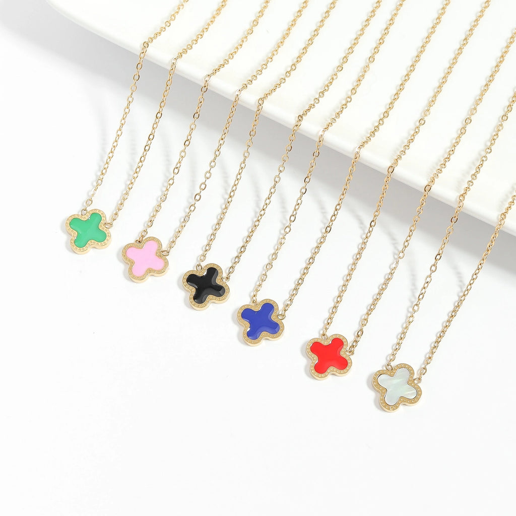 Colorful flower-shaped pendants on gold chains against a white background