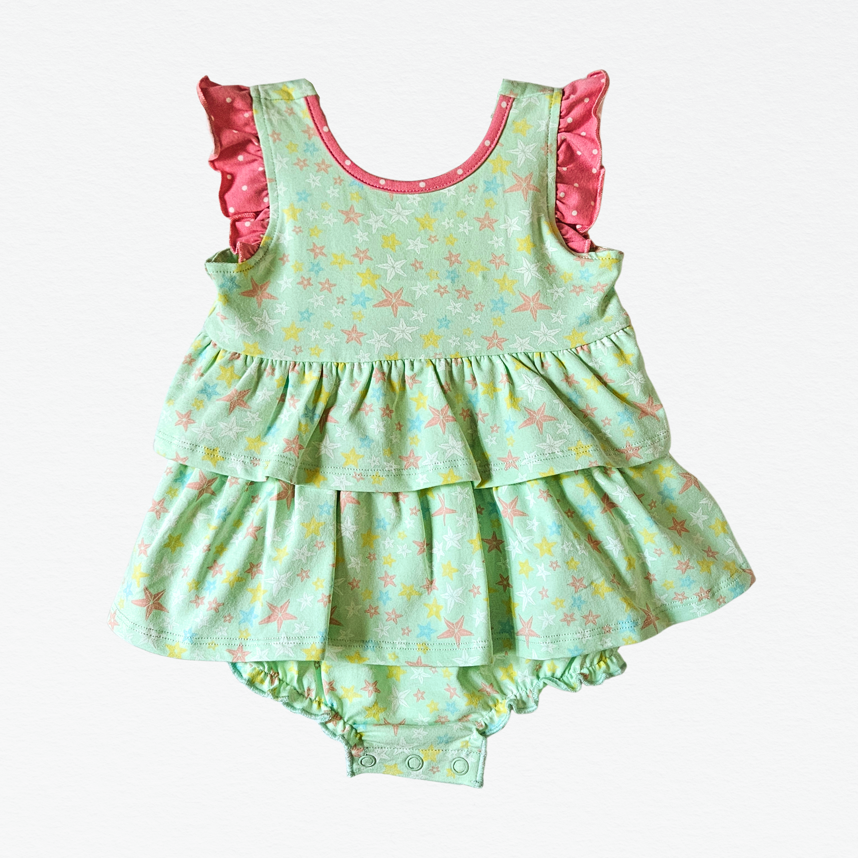 Children's green floral bubble with pink ruffled trim on a white background