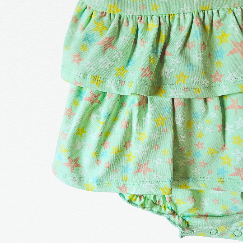 Green baby bubble with starfish pattern on a white background