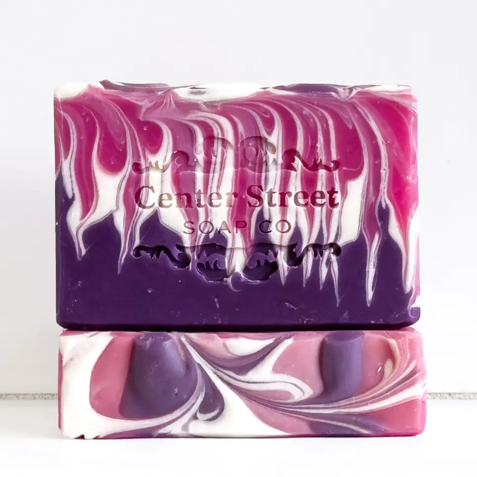 Two swirled purple and pink soap bars with 'Center Street Soap Co' branding on a white background.