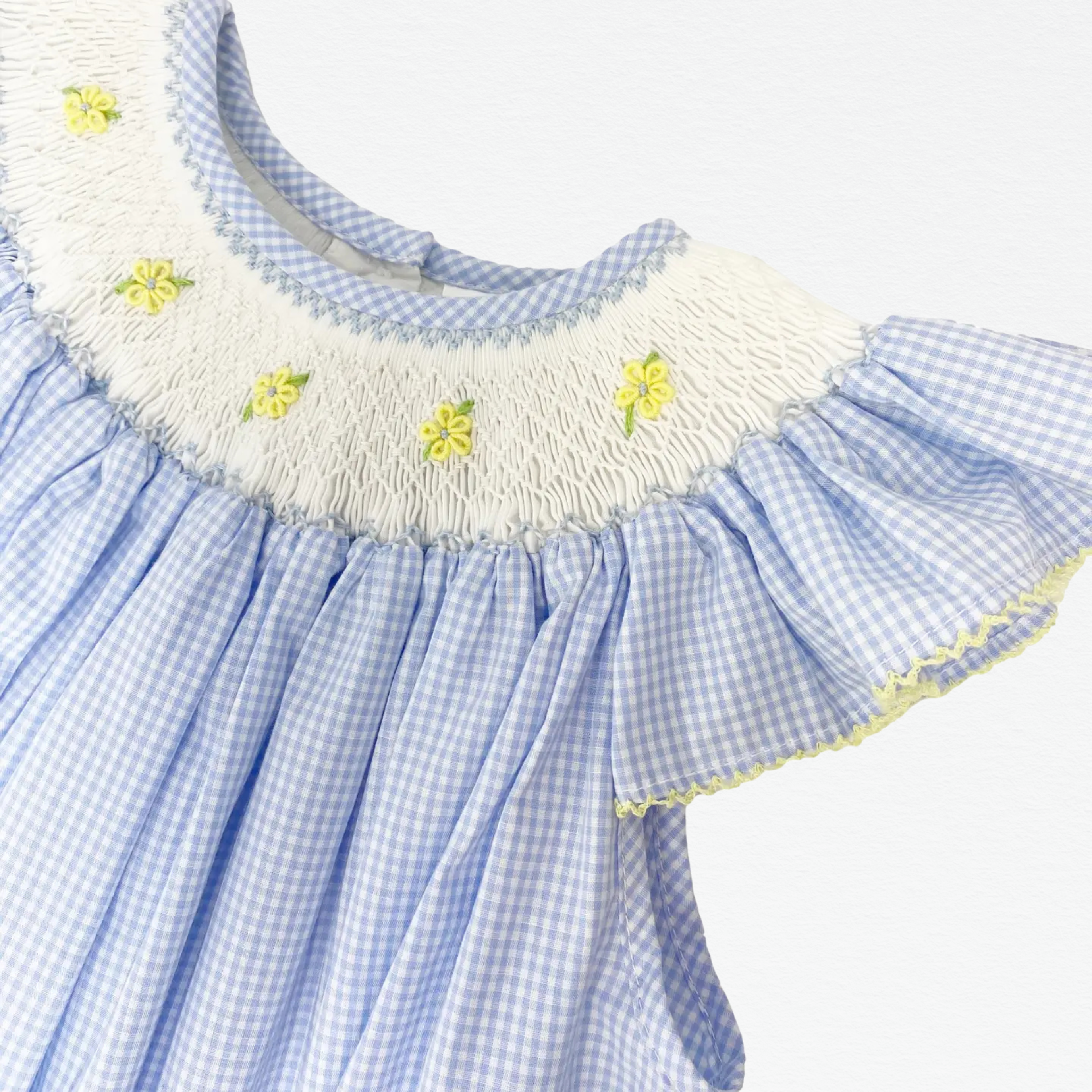 Blue checkered dress with white ruffled collar and yellow flower details on a white background