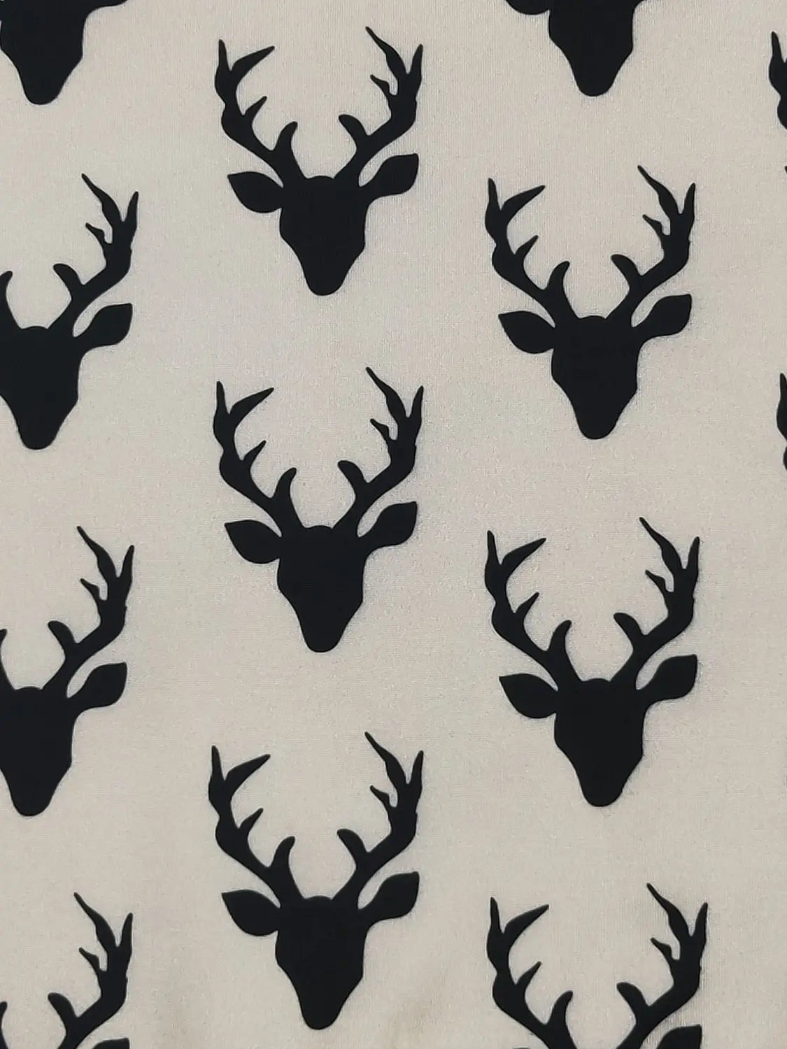 Pattern of black deer heads on a white background