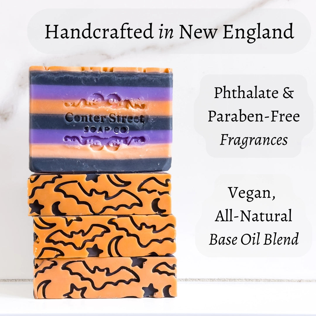 Stack of soap bars with bat design on a white background, featuring text about product details.