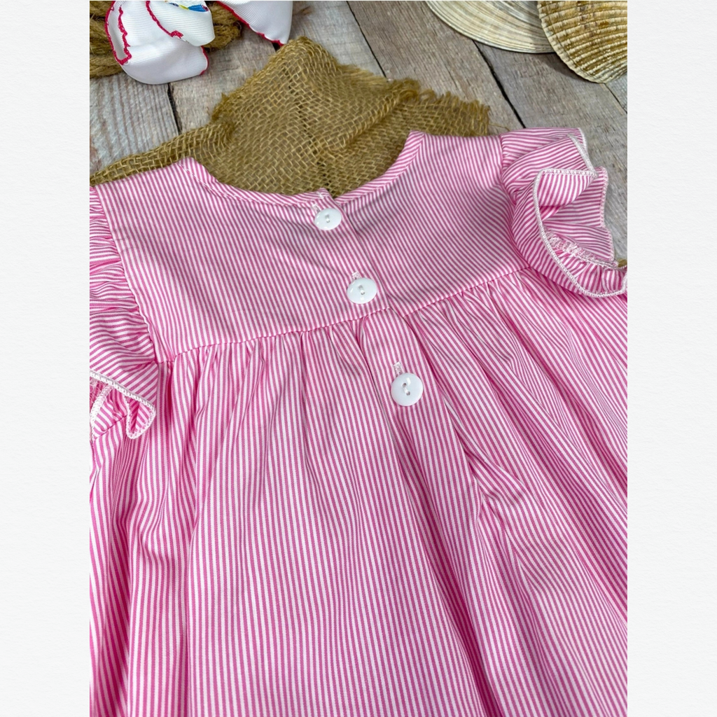 Pink and white striped dress with a green collar on a wooden surface