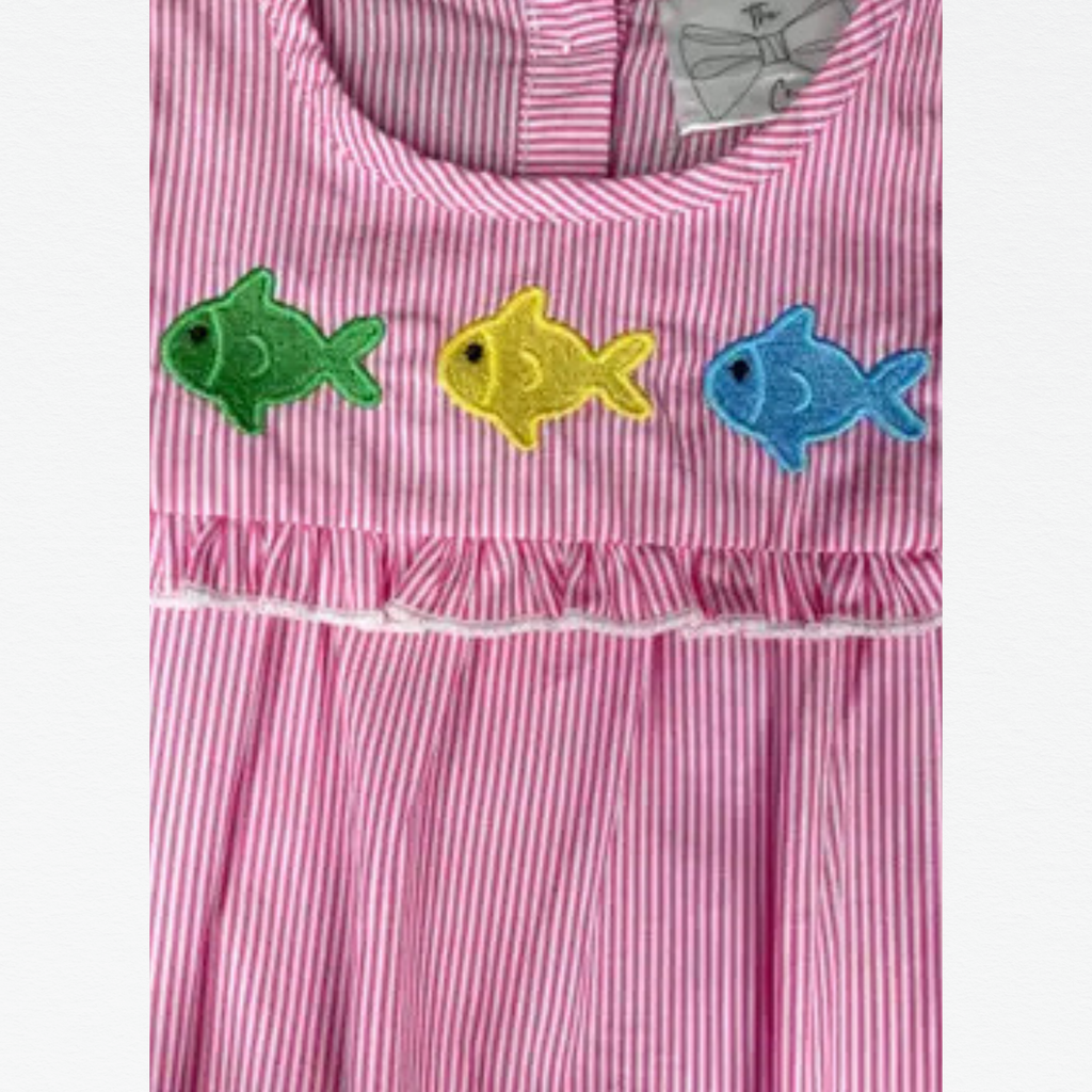 Pink romper with fish embroidery on a white background