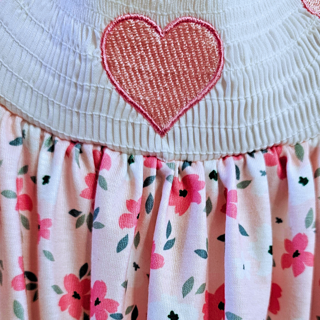 Close-up of a dress with a heart design and floral skirt