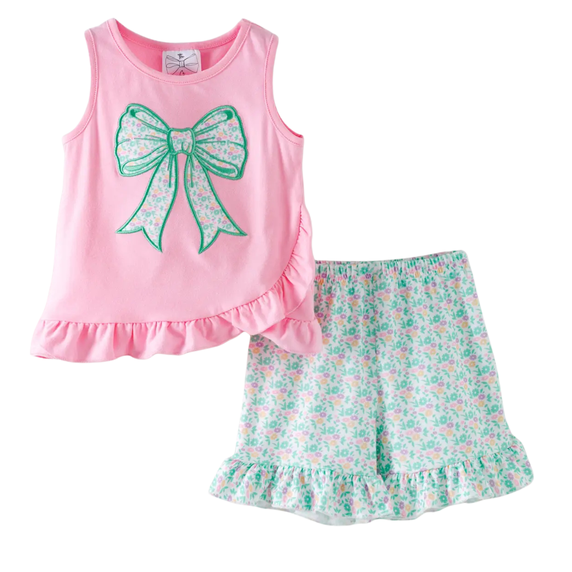 Pink tank top with a green bow and floral shorts on a white background