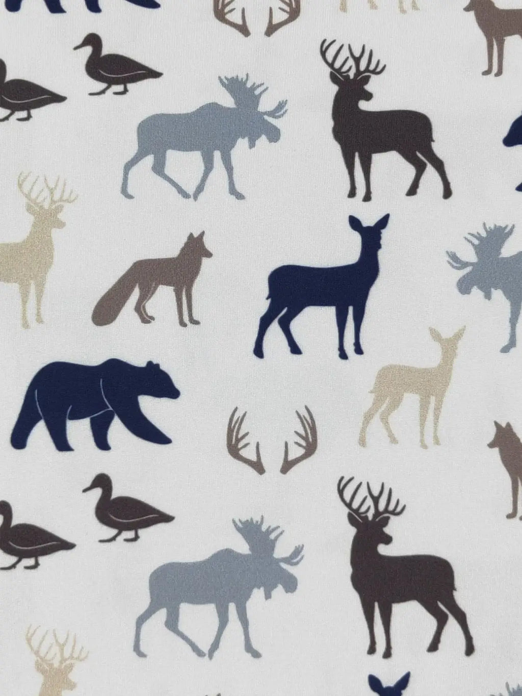 Pattern of forest animals including deer, moose, bear, and ducks on a light background