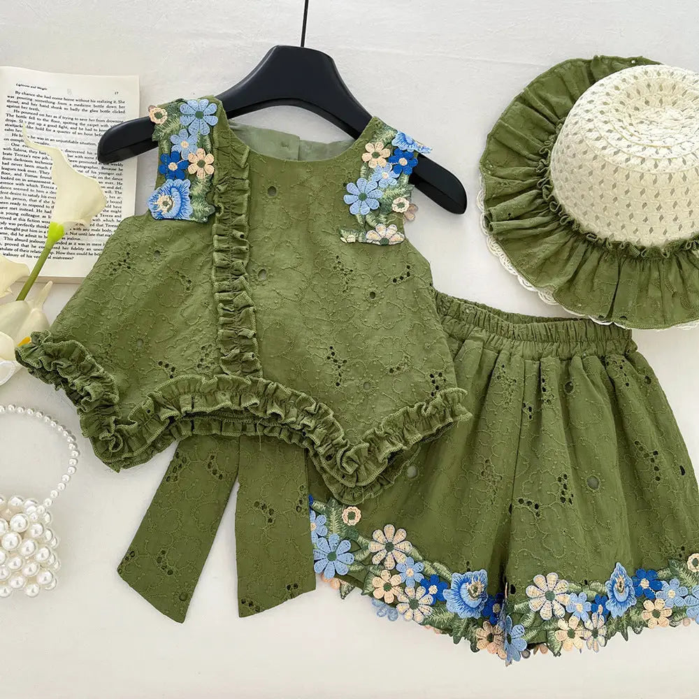 Green children's outfit with floral details on a white background