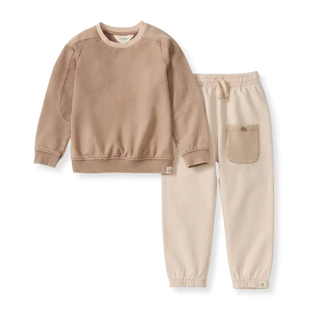 Beige sweatshirt and pants set on a white background
