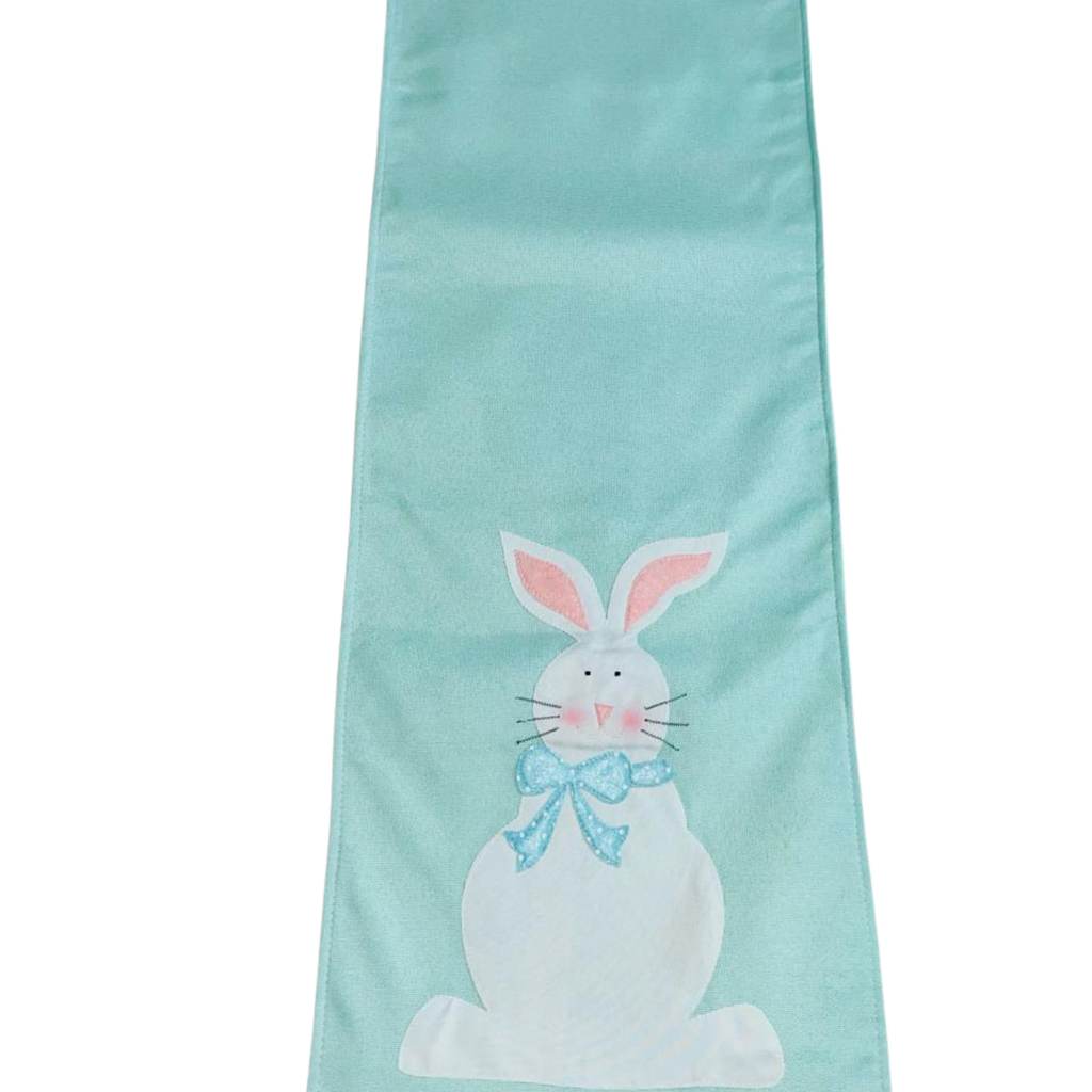 Table runner with a white bunny design on a white background