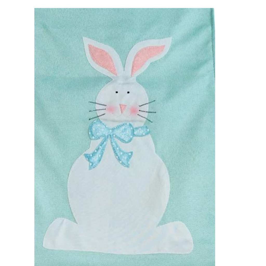 White bunny with pink ears and a blue bow on a light blue background