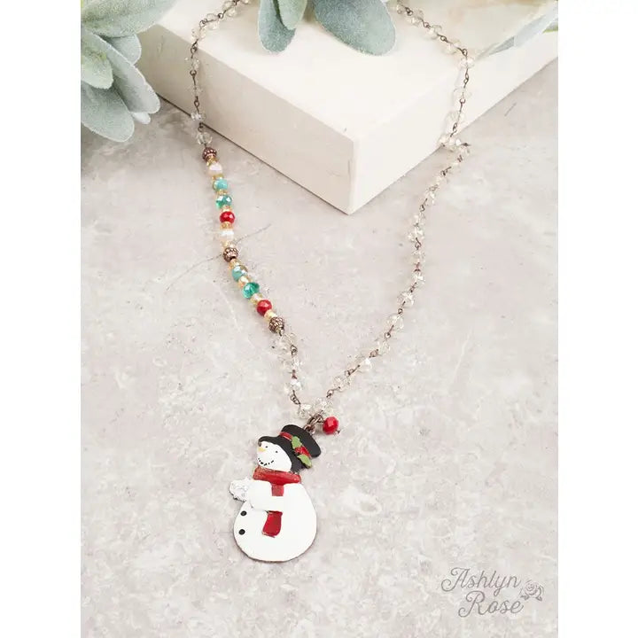 Necklace with a snowman pendant on a light surface