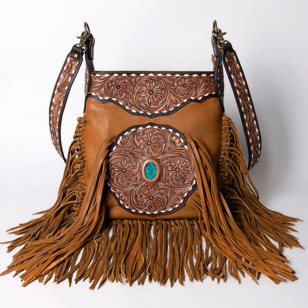 Brown leather handbag with intricate designs and fringes on a white background