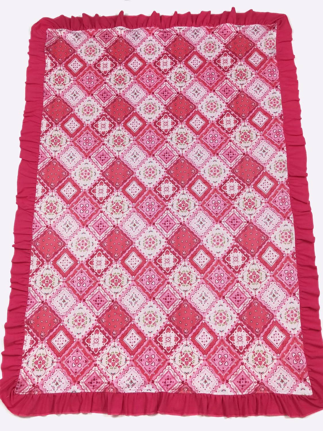 Pink and white patterned blanket with ruffled edges on a white background